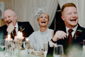 grooms parents laughing during a wedding ceremony