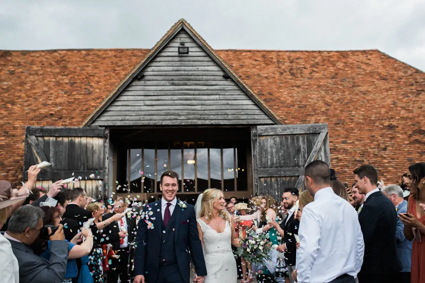 bride and groom being showered with confetti